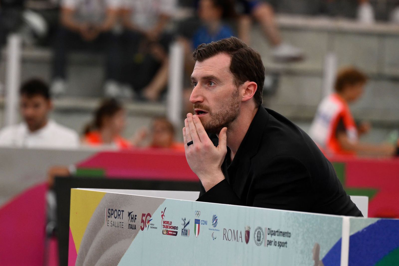 Stephen Lambdin coaching from the sideline at a World Taekwondo event in Rome
