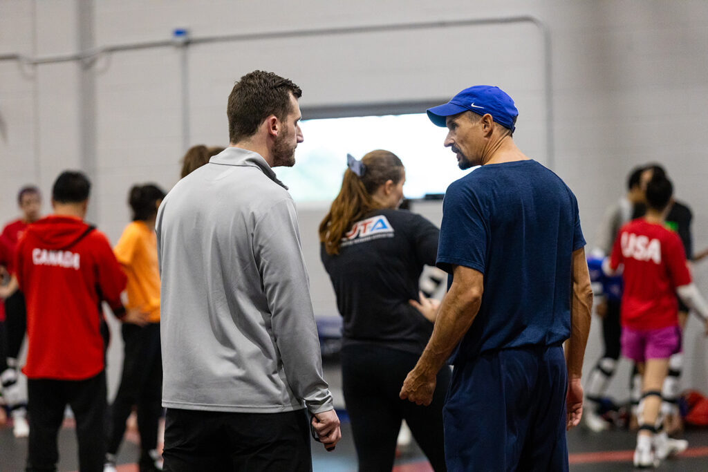 Stephen Lambdin talking with a coach during a training camp