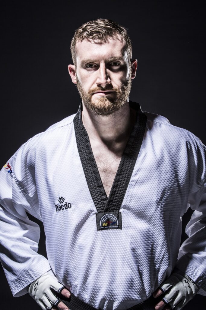 Stephen Lambdin in a black belt taekwondo uniform
